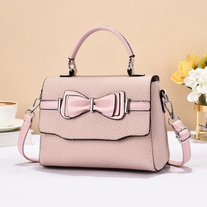 Pink crossbody bag with a chic bow and woven texture for a stylish everyday look