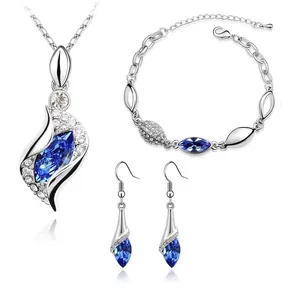 Blue crystal jewelry set featuring silver necklace, bracelet and earrings on white background