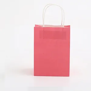 Pink medium kraft paper shopping bag with white twisted handles and serrated edge detail