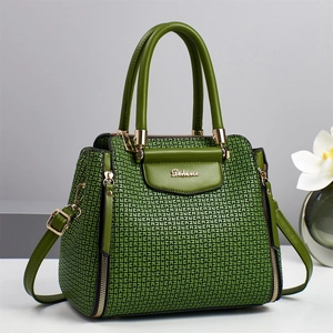 Green Boston handbag with geometric embossed pattern and adjustable shoulder strap