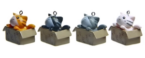 Close-up of four cute 3D cartoon cats in small cardboard boxes with keychains