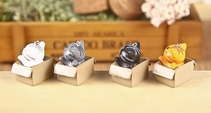 Close-up of four cute 3D cartoon cats in boxes keychain set with metal rings