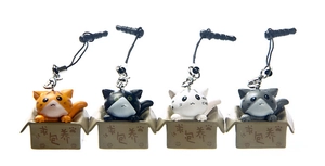 Detail showing four styles of cartoon cats in cardboard boxes as phone dust plugs