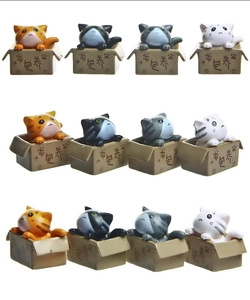 Macro shot of 3D plastic cartoon cats in miniature boxes from multiple viewing angles