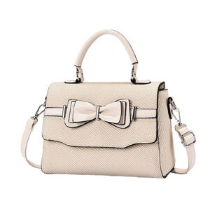 Elegant beige woven crossbody bag with leather bow detail and silver metal hardware