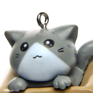 Close-up of cute 3D cartoon cat keychain with matte grey and white finish and metal ring