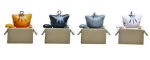 Detailed back view of four 3D plastic cartoon cats in boxes for keychains and charms