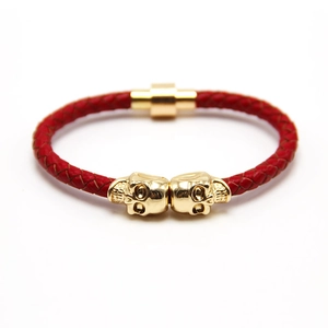 Men's punk braided red leather skull bracelet with gold magnetic clasp on white background