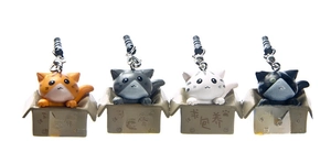 Macro view of four 3D plastic cartoon cats in mini boxes with metal lobster clasp hooks