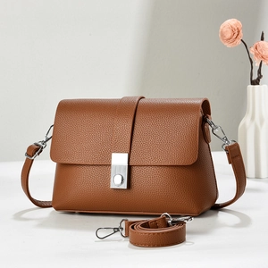 Brown litchi grain leather crossbody bag with silver buckle and detachable shoulder strap