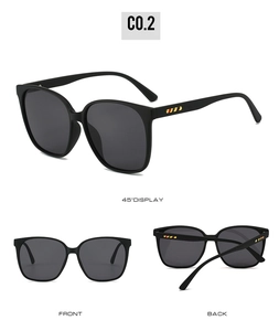 Detail view of retro square sunglasses with yellow stripe accents on matte black frames