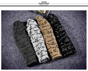 Detail of vintage script printed cotton beanies in dark grey, khaki and black colors