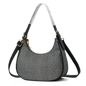 Women's woven shoulder bag with black and white zigzag pattern and gold hardware