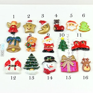 Flat lay macro view of sixteen assorted colorful Christmas resin DIY flatback charms
