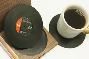 Close-up of retro vinyl record coasters with a vintage wooden storage box