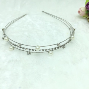 Close-up of double-layer silver headband featuring white pearls and sparkling rhinestones