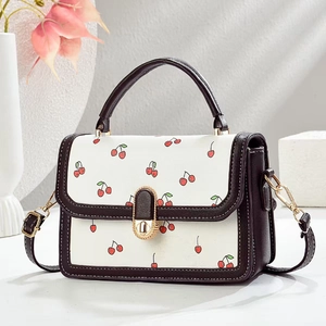 Elegant white crossbody mini square bag with cherry print and dark brown handles