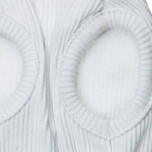 Close-up of white ribbed knit fabric detailing sleeve openings on a pet vest