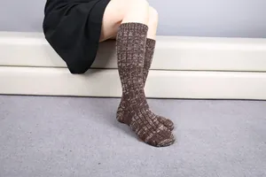 Close-up of thick knit knee-high socks in brown and white blend with ribbed cuffs