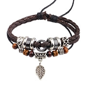 Close-up of a handmade multilayer braided leather bracelet with leaf charm and metal beads