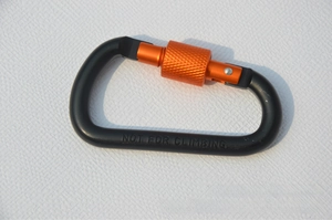 Detail of black D-ring carabiner with orange screw lock and NOT FOR CLIMBING warning