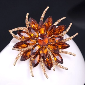Elegant amber crystal flower brooch with gold tassels and cubic zirconia accents