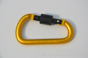 Detail of 8cm D-ring carabiner with black screw lock and yellow aluminum finish