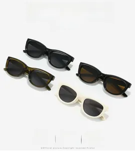 Détail de lunettes de soleil tendance en noir vert caramel et blanc crème élégantes