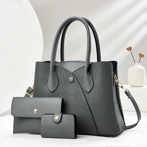 Three-piece women's tote bag set with woven texture and matching pouches in dark grey