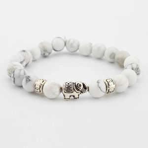 Detail of beaded elephant bracelet with white turquoise stones and silver-tone spacer beads