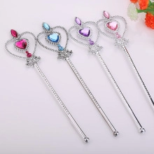 Detail of four colorful toy fairy wands with heart-shaped gems and silver finish