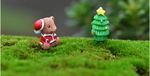 Makroaufnahme von braunem Bär und Tannenbaum aus Harz für Moos-Mikrolandschaften