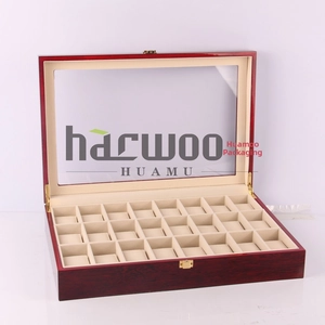 Detailed view of 30-slot wooden watch box with open glass lid and soft beige cushions