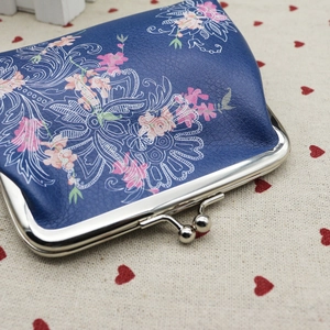 Detail of floral PU leather coin purse with vintage silver metal clasp on heart fabric