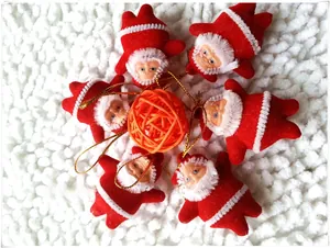 Set of 6 Santa figurines in red velvet with gold cords on white plush background