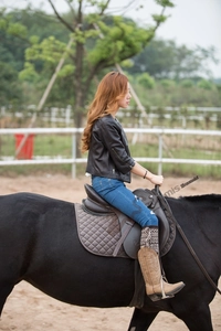 Bohemian knit leg warmers with fringes styled with tall brown boots and riding outfit
