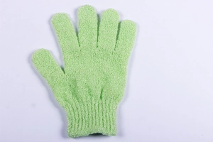 Detailed macro view of light green exfoliating nylon bath glove with elastic wrist cuff