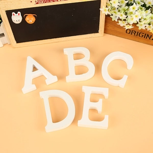 Set of five white wooden 3D letters A to E for wedding decor and photography props