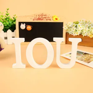 Close-up of white wooden IOU letters for home wedding decor and photography props