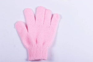 Close-up of pink nylon exfoliating bath glove with elastic wrist and textured fabric