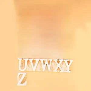 Flat lay of complete 26 white 3D wooden English alphabet letters set on orange background