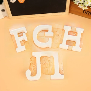 Detail of white matte wooden letters F G H J I for home wedding decor and photo props