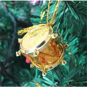 Close-up of golden decorative mini drum ornament with metallic finish for Christmas trees