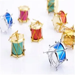 Close-up of colorful mini drum Christmas ornaments with metallic finish and gold threads