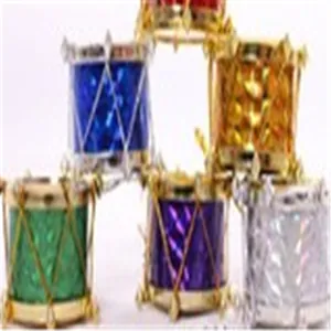Close-up of colorful mini Christmas drum ornaments with gold strings and metallic finish