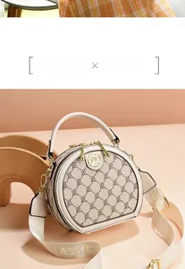 Detail of beige round crossbody bag with geometric pattern and classic wide strap