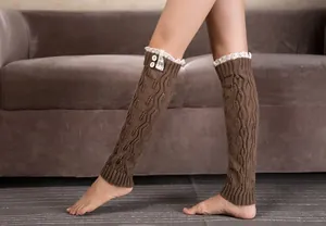 Detail of brown cable knit leg warmers with delicate white lace trim and button accents