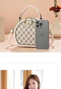 Detail of off-white semi-circle crossbody bag with & pattern and dual gold zippers
