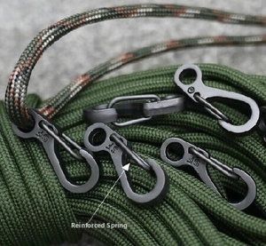 Detail of matte black SF tactical carabiner with reinforced spring and military green cord