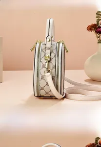 Detailed views of a mini round crossbody bag featuring beige monogram canvas and leather